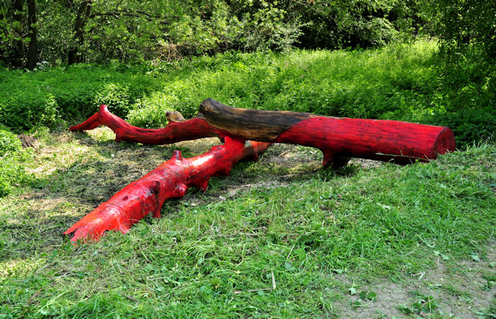 Painted tree sections form an installation created by artist Robbie Scandrett for the 3Rs sculpture trail