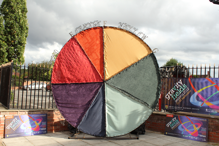 Daytime view of Isaac Newton Colour Circle - an artwork in steel and fabric by sculptor Laury Dizengremel
