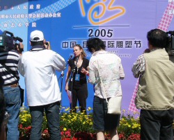 Opening Ceremony - Laury giving a speech in front of the crowd and the press
