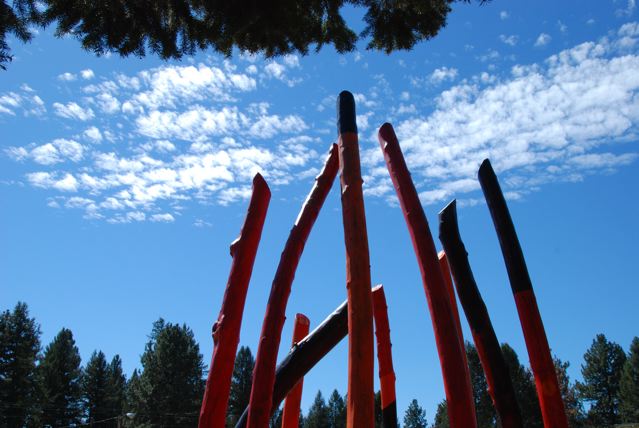 Log Henge timber circle / woodhenge sculpture installation profiled against Montana big sky country