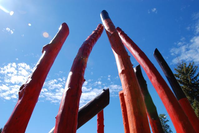 Close up on profile of Log Henge - Spirits of the Forest against Montana sky