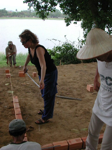 Working the basic foundation line for the first brick wall of this site-specific sculpture in Hue